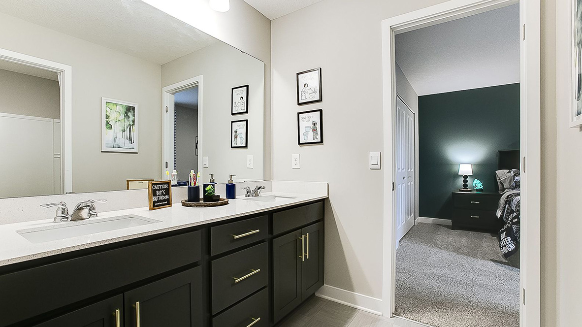Jack and Jill bathroom with quartz double vanity and harbor gray cabinets.