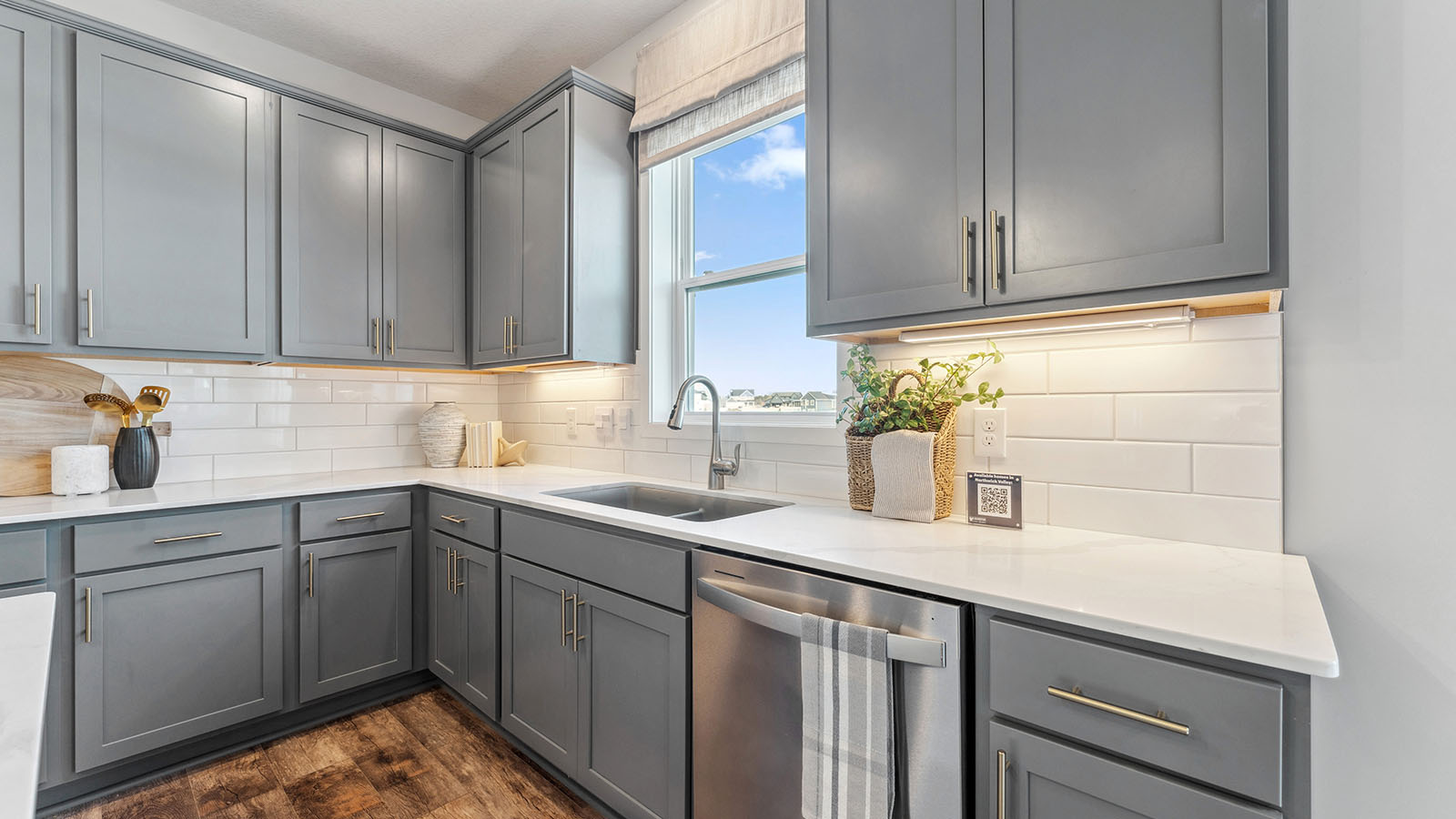 Stainless steel dishwasher and sink included with kitchen