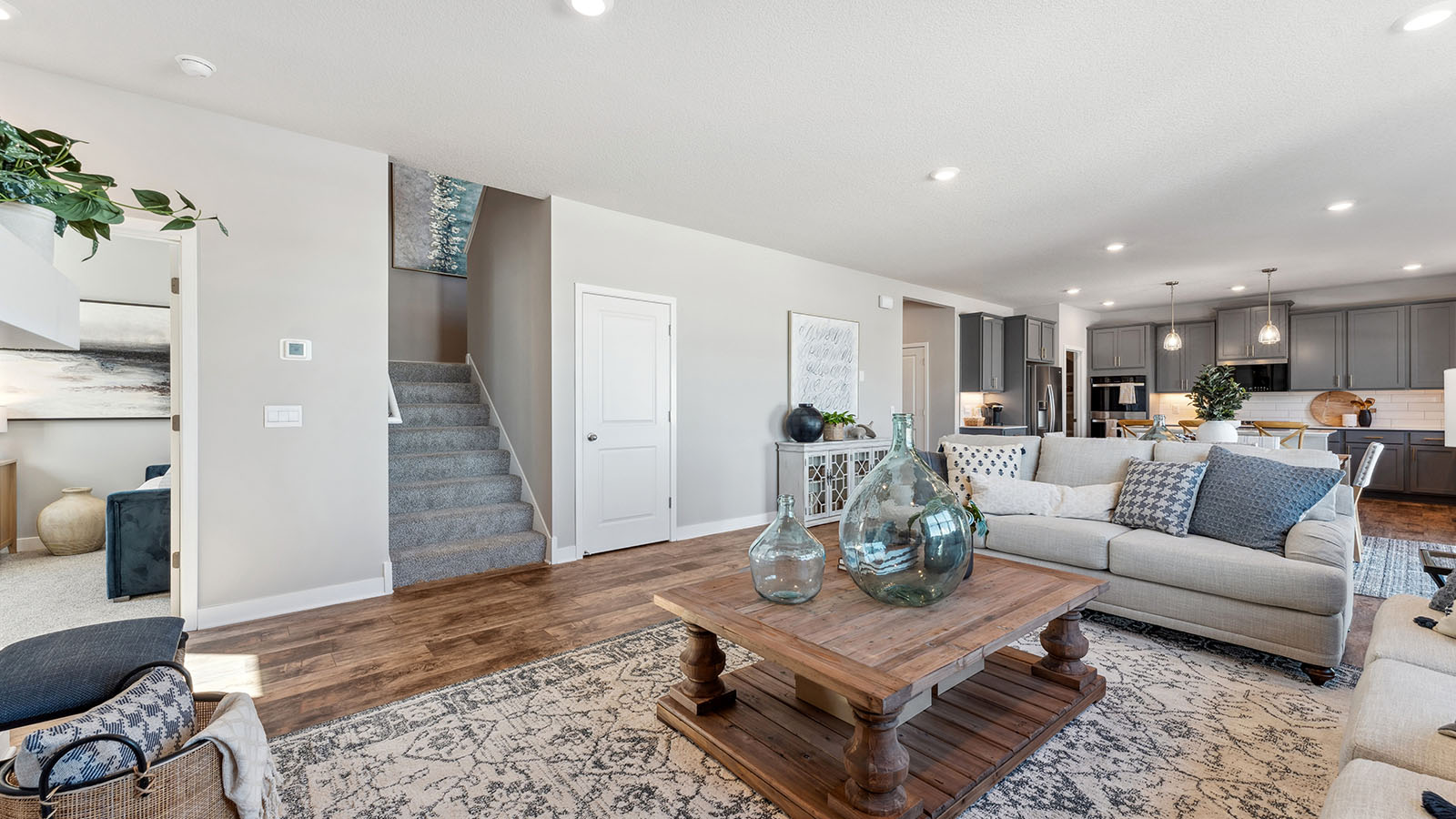 The carpeted staircase adjacent to living room area