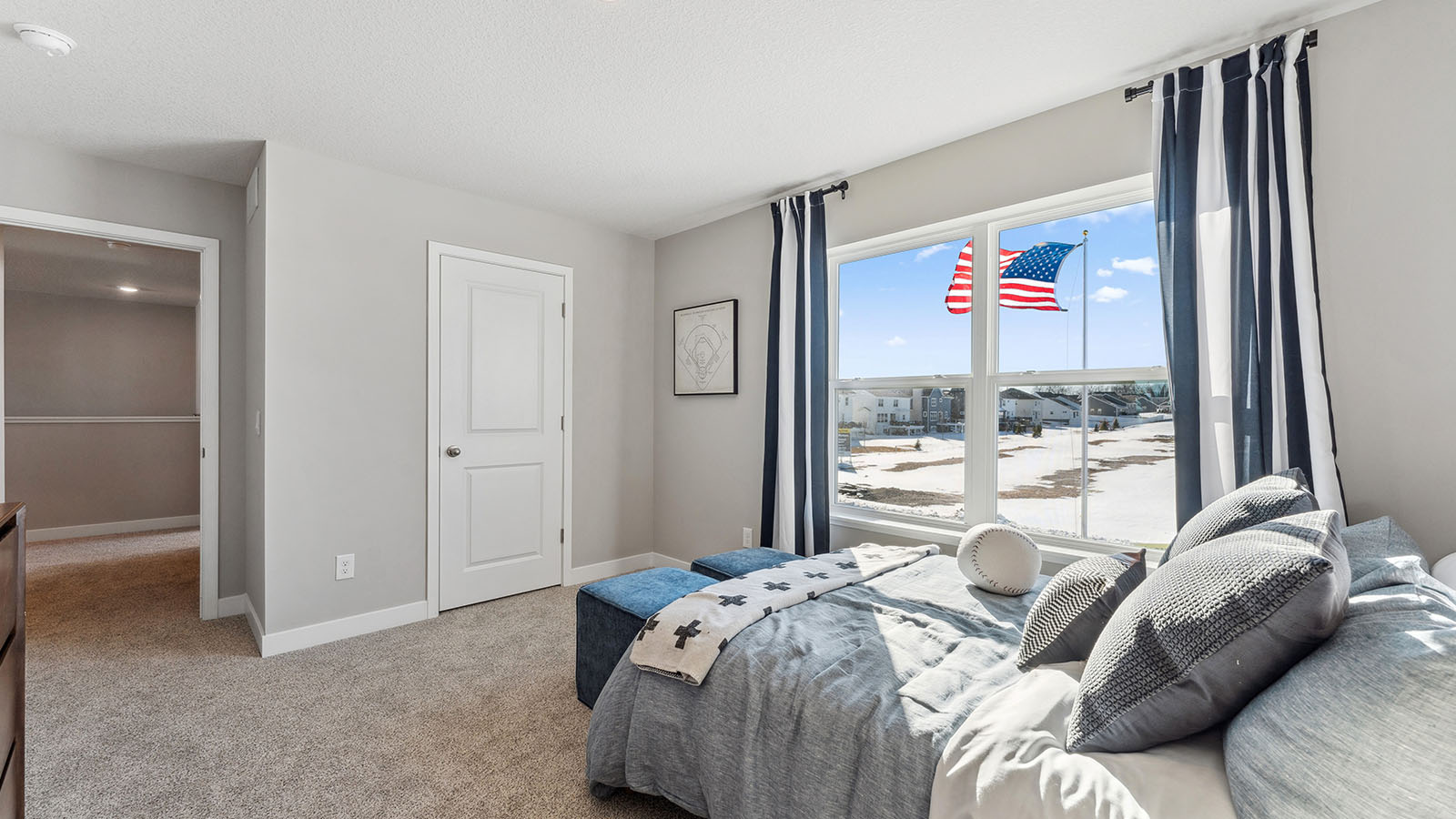 Carpeted secondary bedroom on upper level with walk in closet and private bathroom