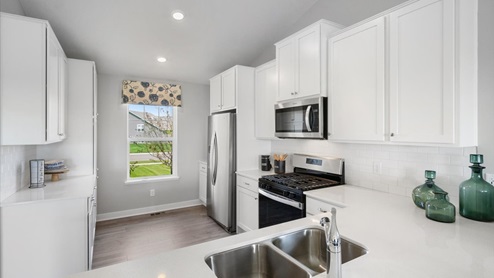 The kitchen includes stainless appliances.