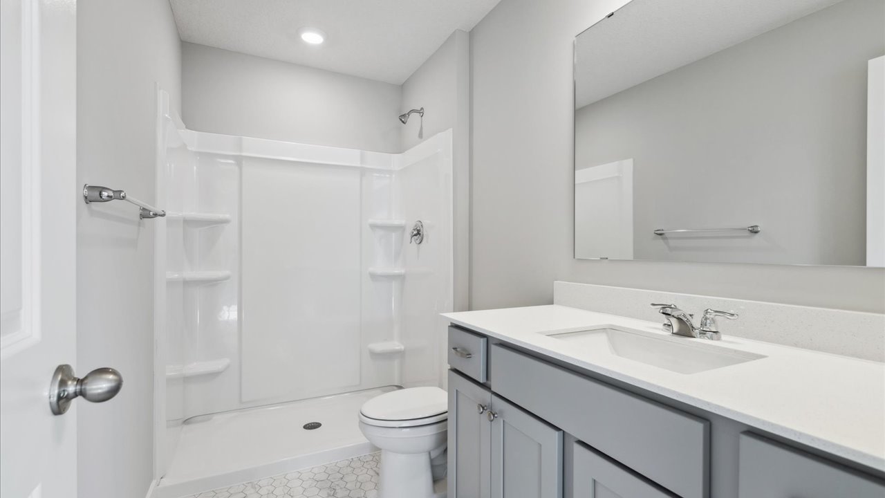 Owner’s ensuite vanity with tub shower combo Ravine Crossing By D.R. Horton