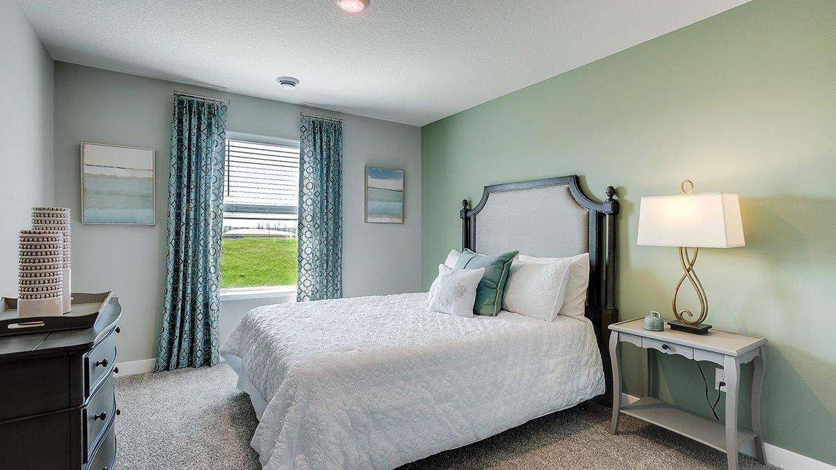 Secondary bedroom in walkout-style basement.