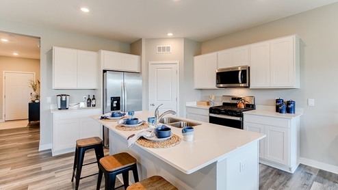 The Henley kitchen with white cabinets and stainless appliances.