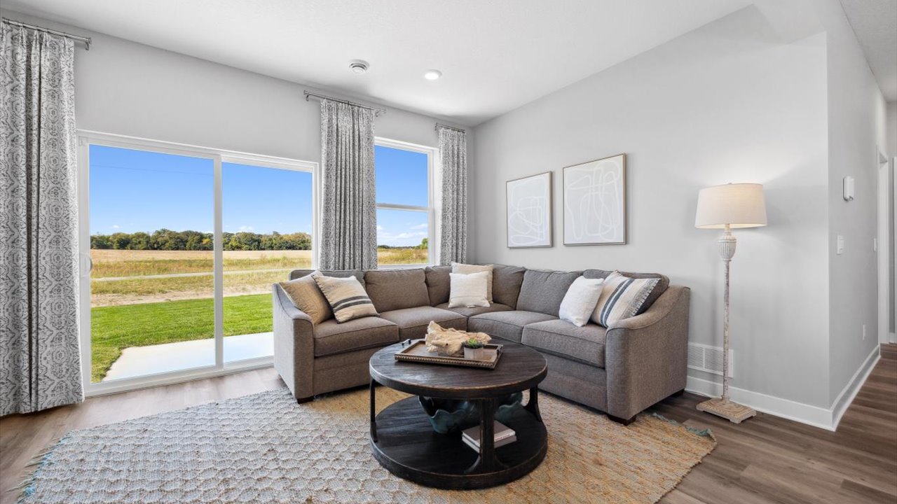 Living room with hard flooring and electric fireplace.