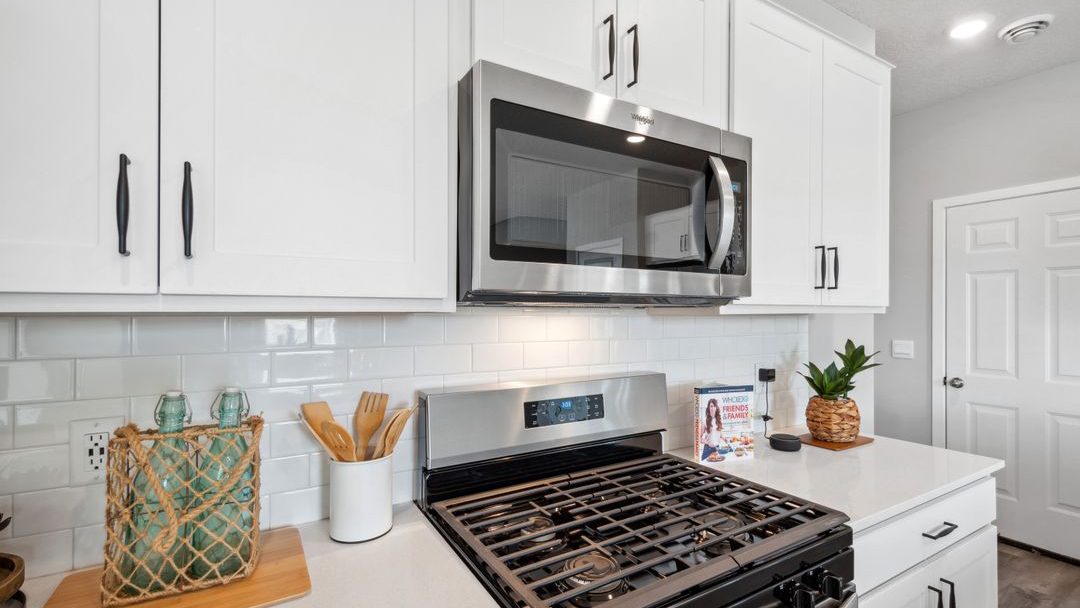 Kitchen with white cabinets and stainless steel appliances.