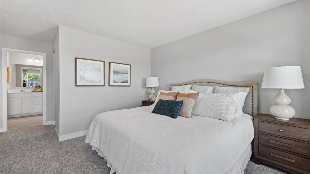 Bedroom suite with dual walk-in closets and private bathroom.