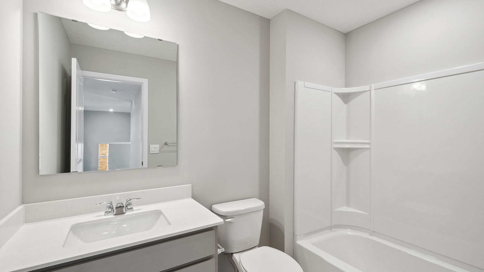 Family full bathroom 3 with stylish vanity, mirror, polished fixtures, cabinets, tub-shower combo Harvest View By D.R. Horton