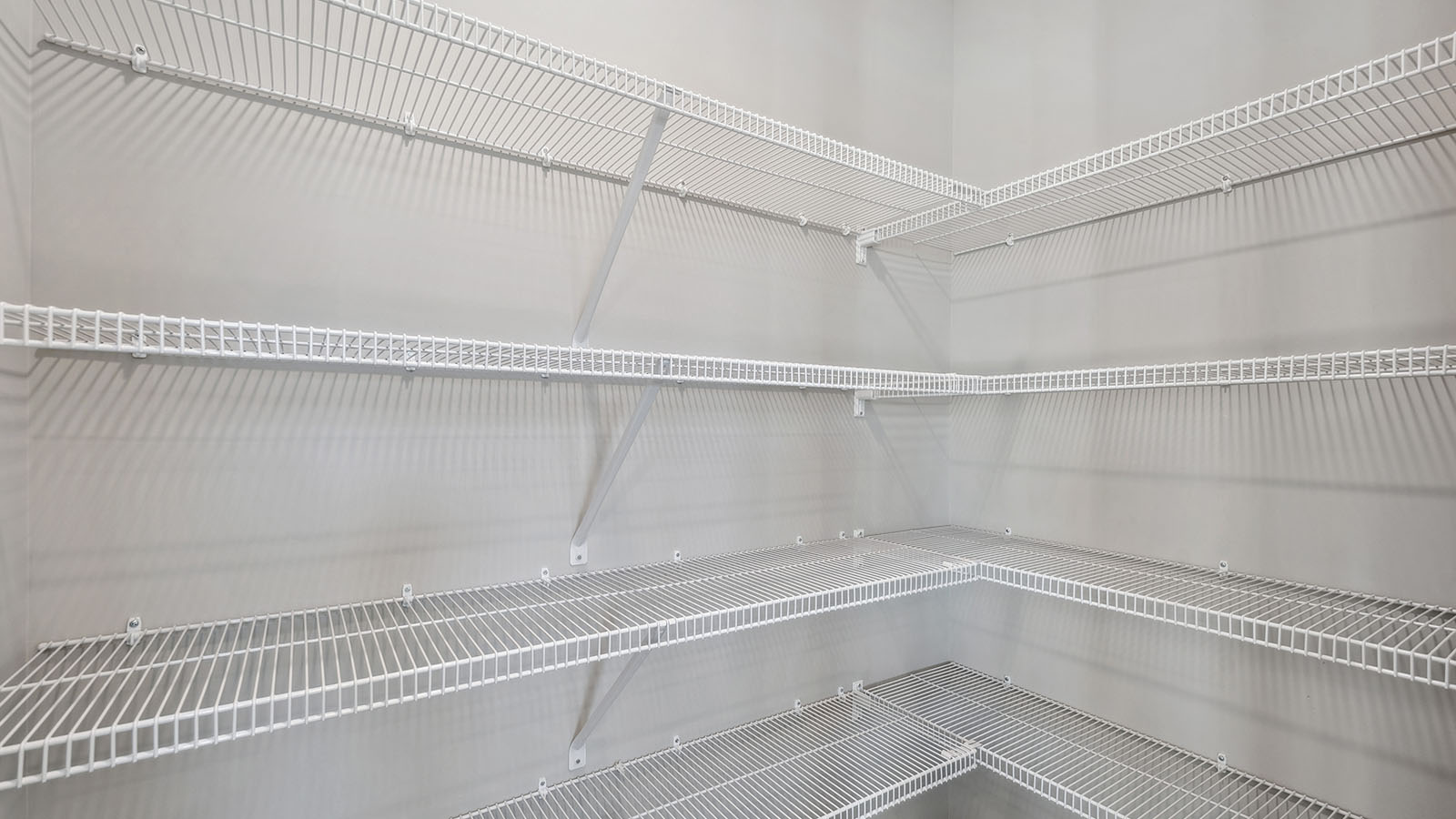 Kitchen pantry inside view in this new build home adds floor-to-ceiling shelving, optimal storage opportunities