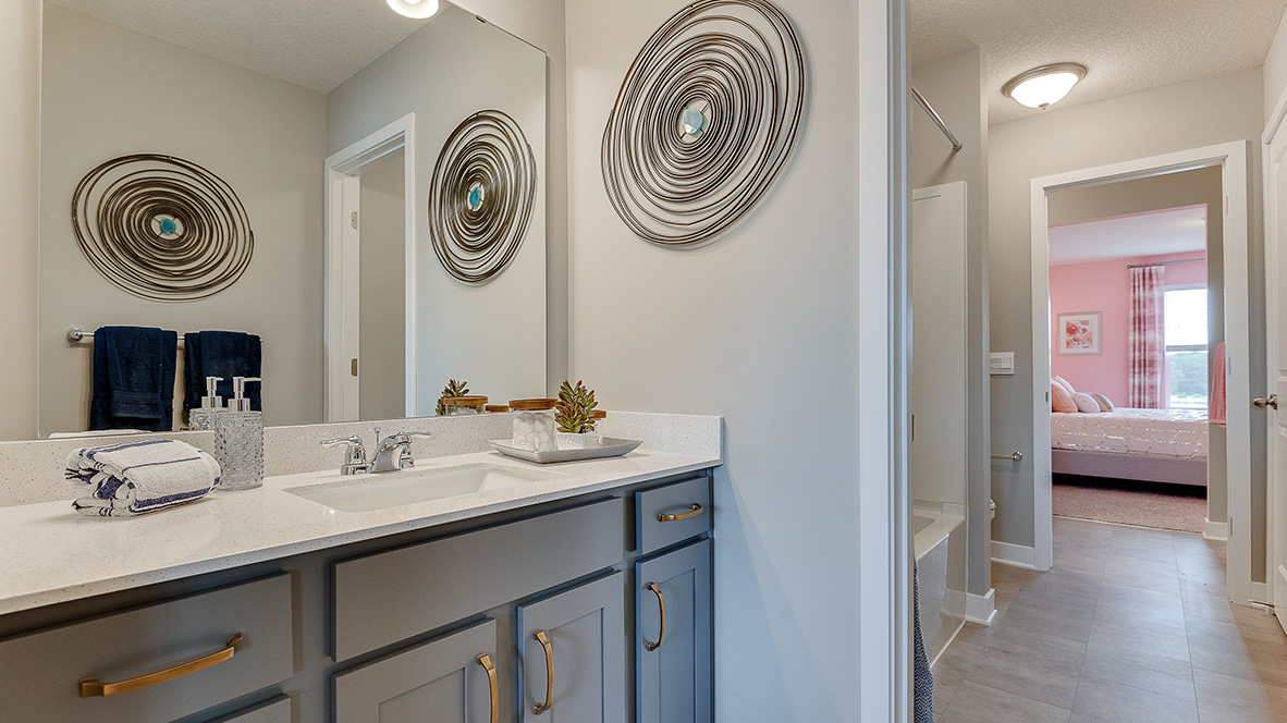 Jack and Jill bathroom with harbor gray cabinets and quartz countertops.