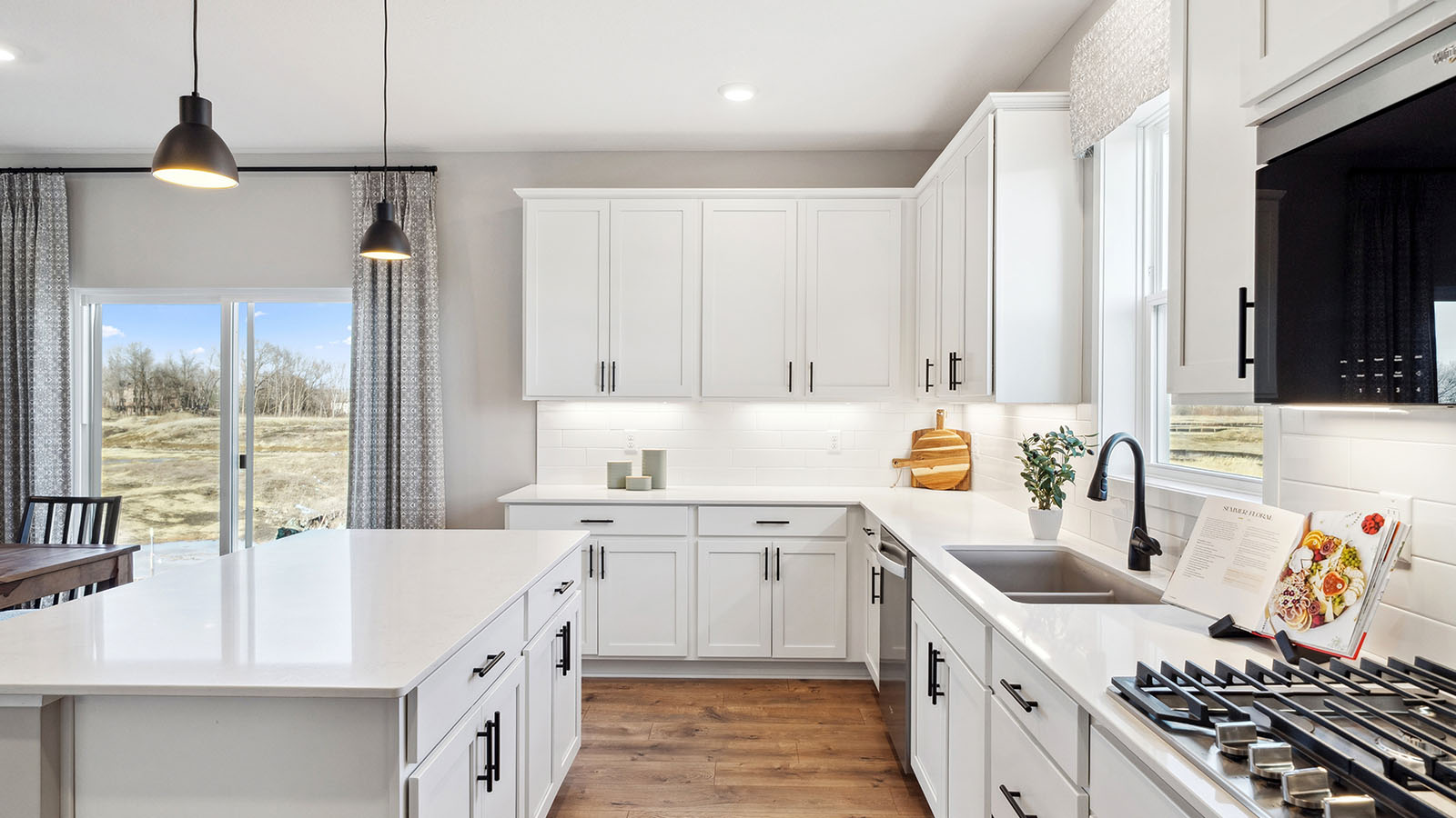 New home kitchen island with sink, seating, pantry, cabinets, new appliance suite included