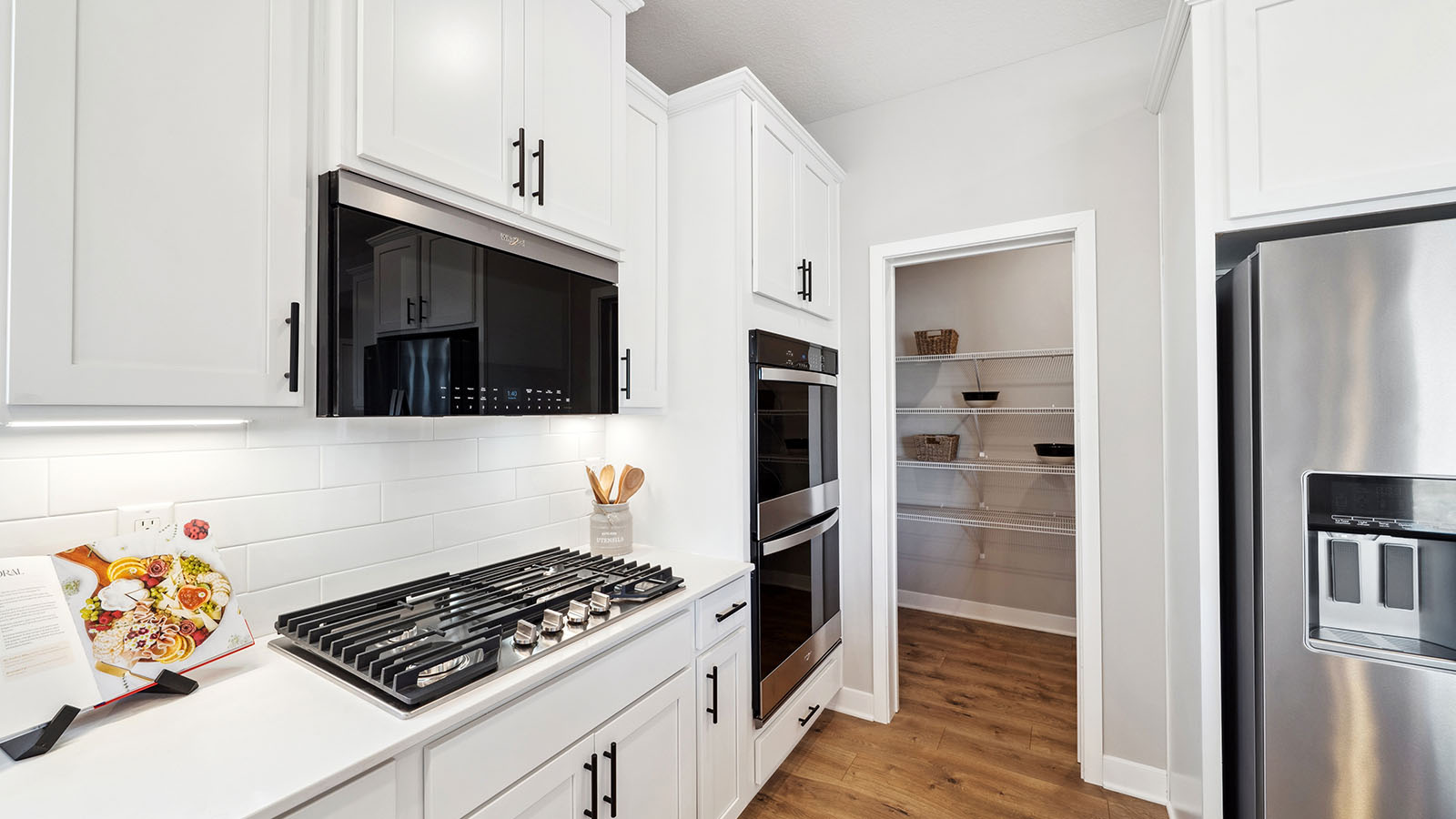 Island kitchen design offers new appliance suite included, storage, pantry, sink, and prep zones