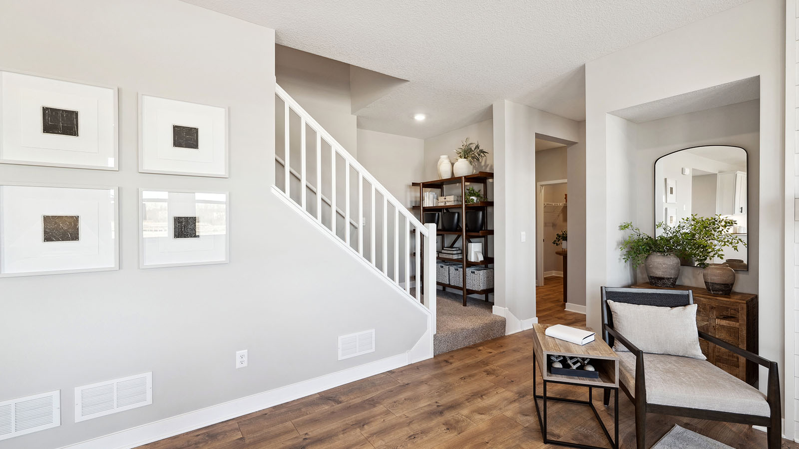 Living room looking to front entry with stair and garage access enhancing home connectivity