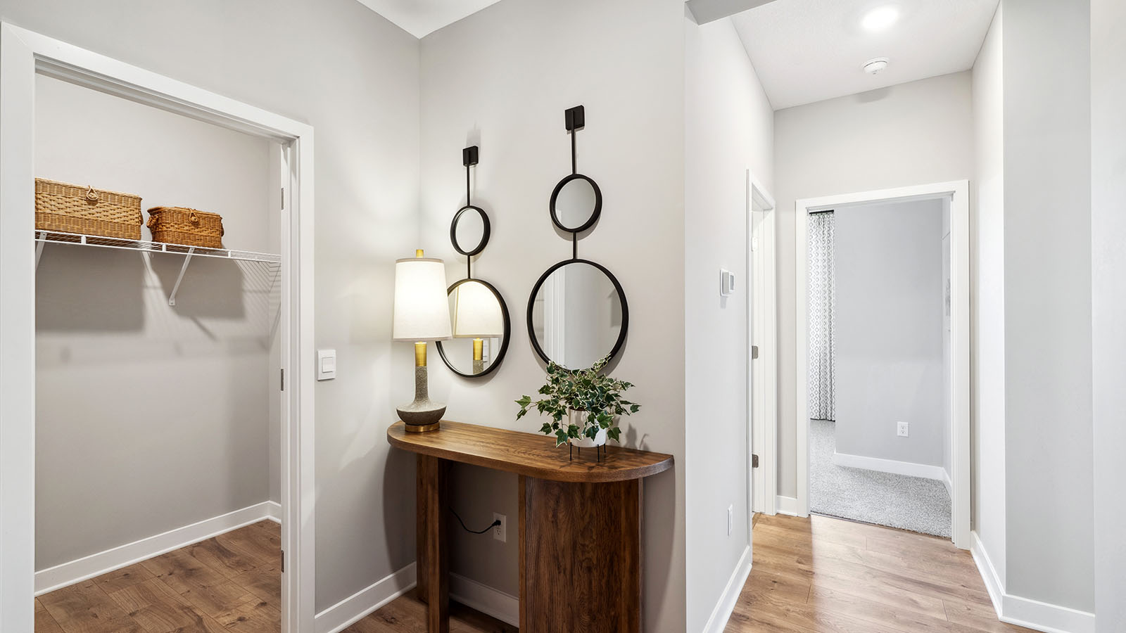 Interior hallway providing access to half bath and Bedroom 2 near main living areas
