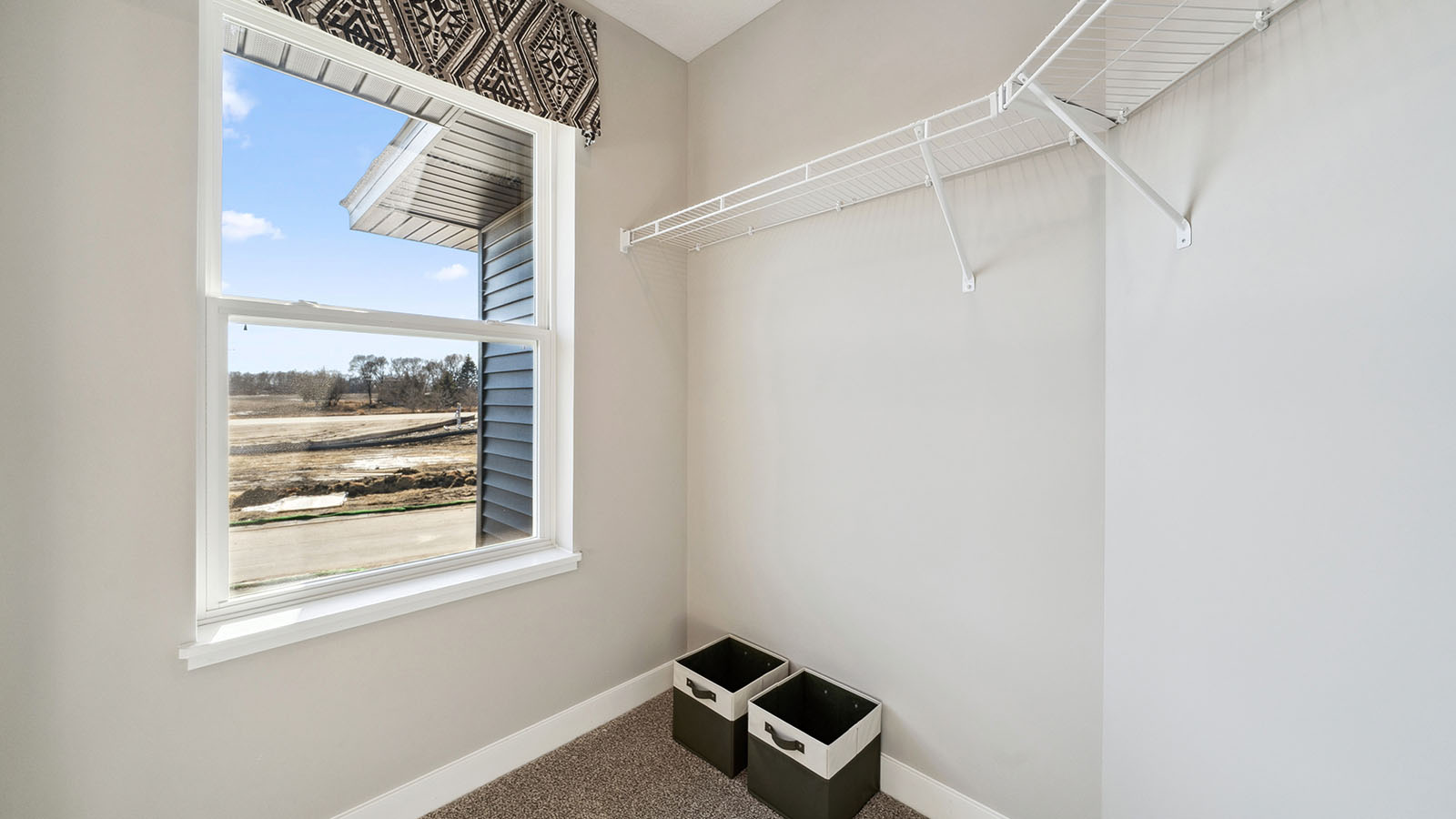Interior view of upstairs walk-in closet providing organized storage space