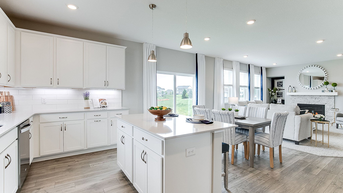 View of open concept main level with island in foreground.