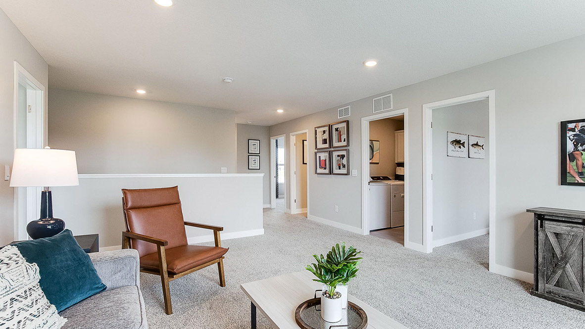 Upper level carpeted loft with living area.