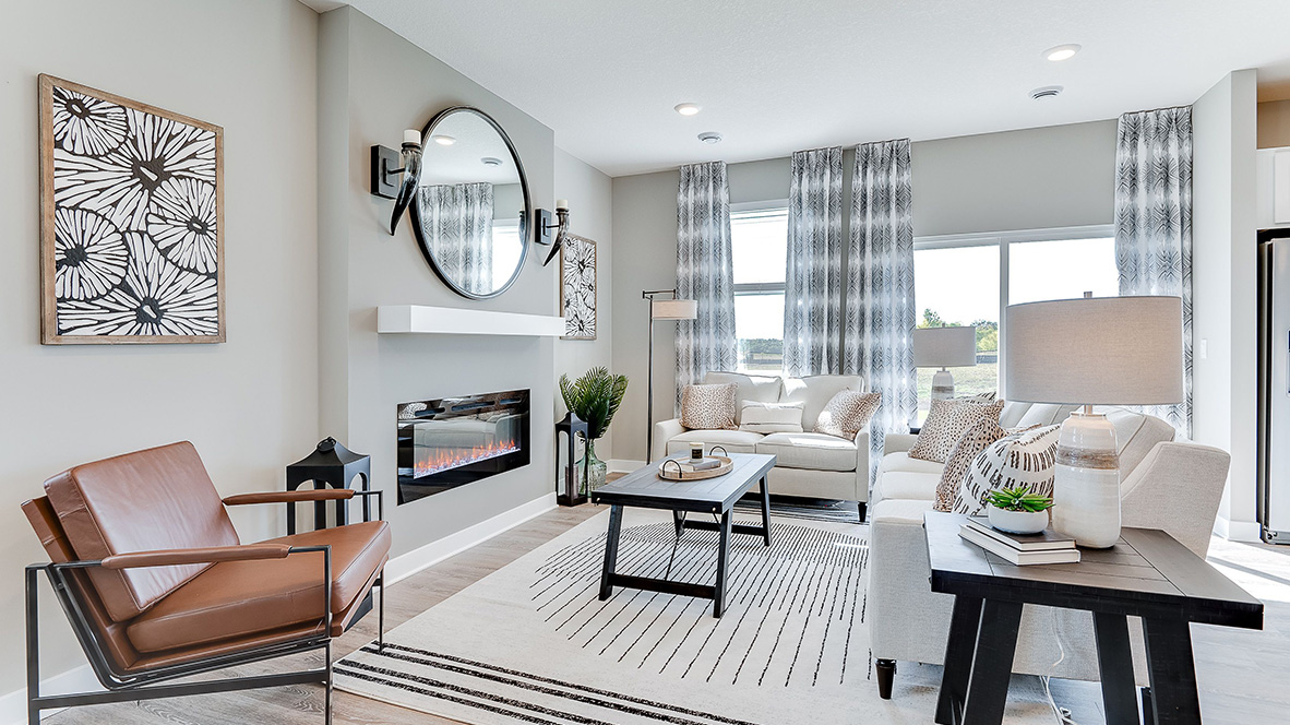 Family room with hard flooring and electric fireplace.