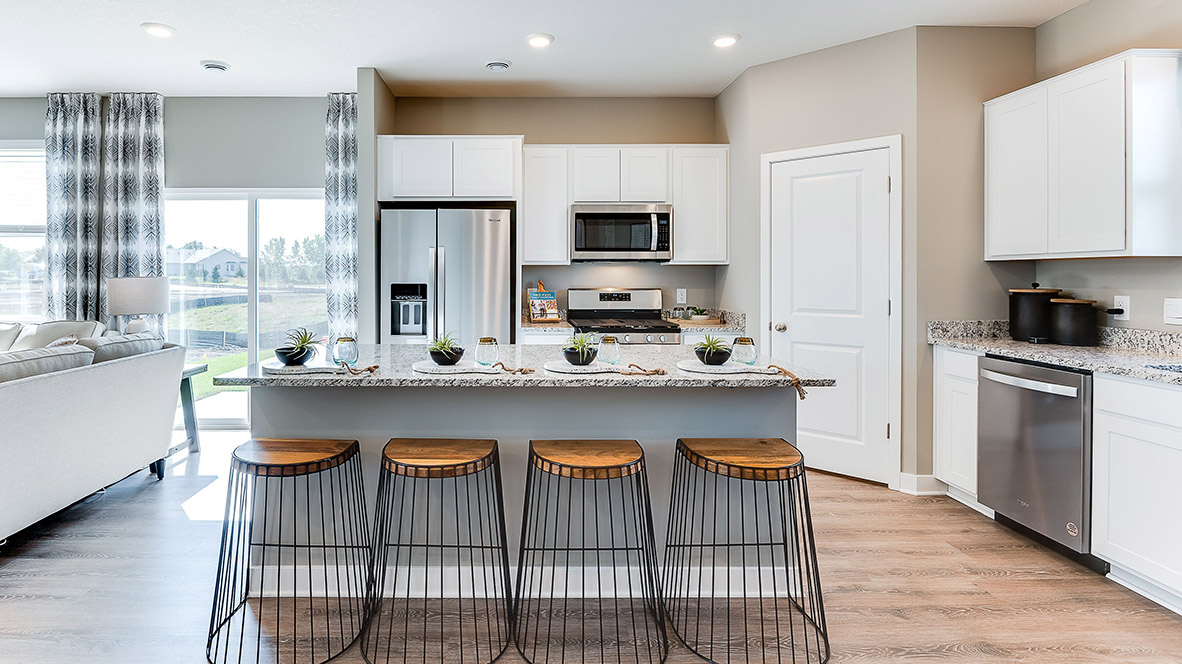 The kitchen with a walk in pantry and stainless appliances.