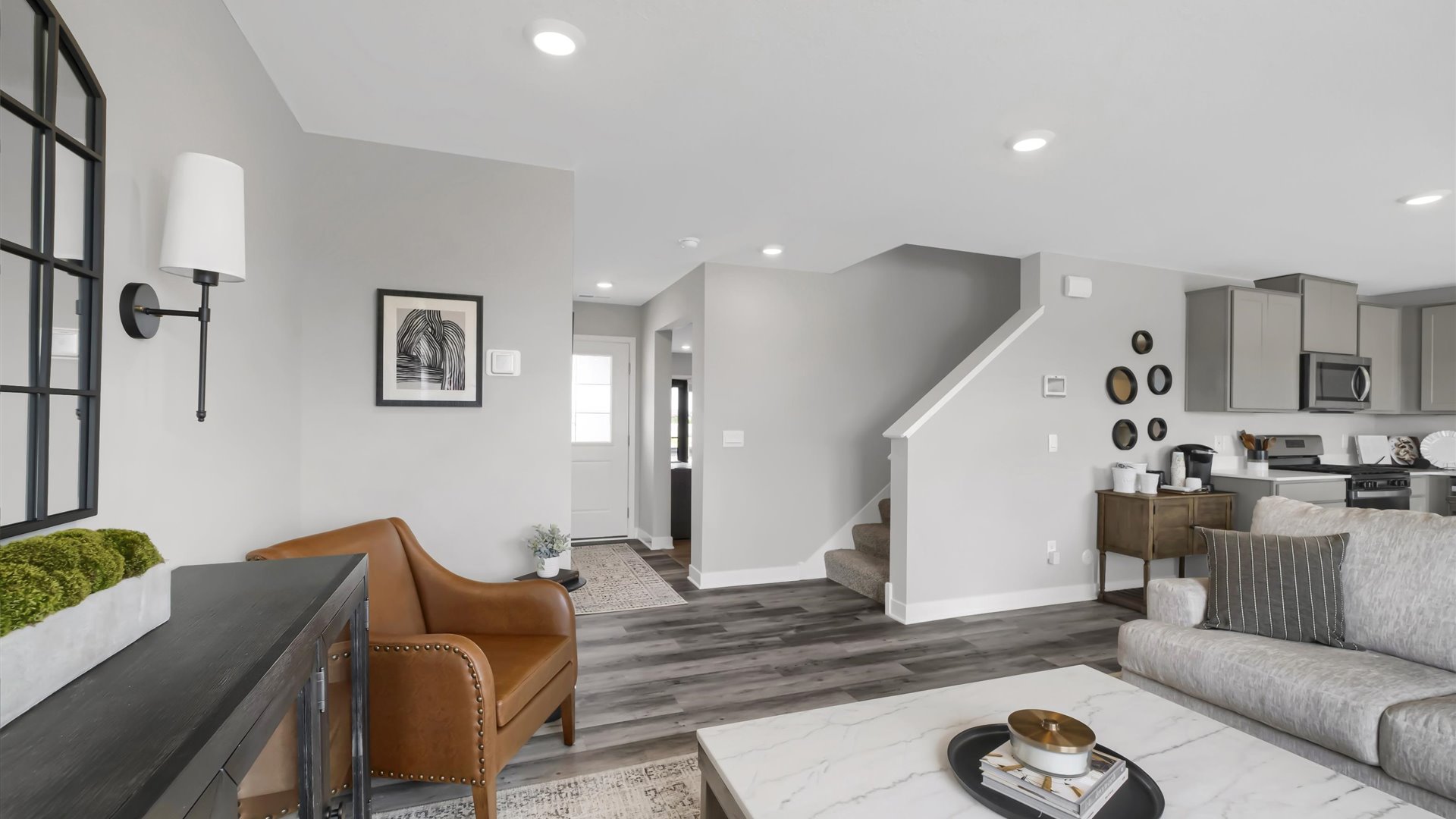 View of stairwell and entry area on open concept main level.