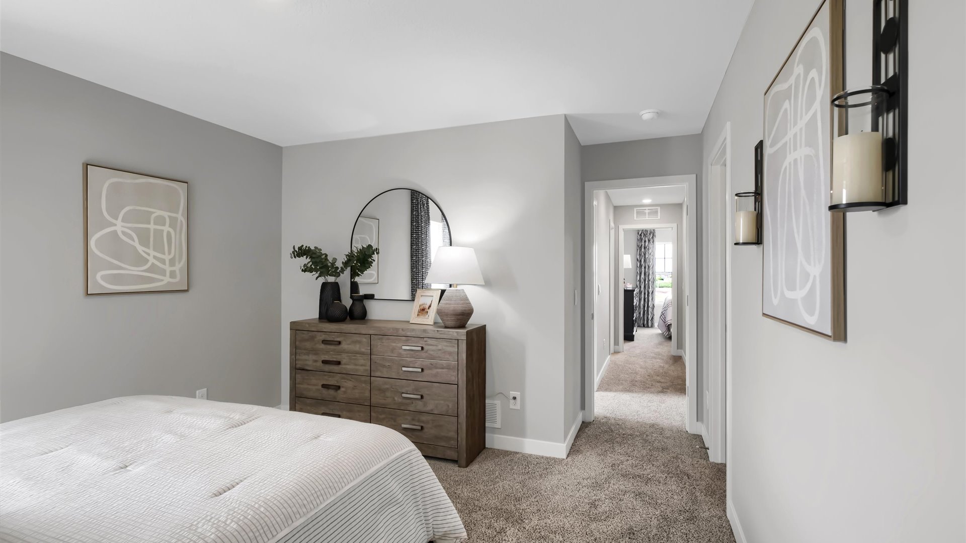 Carpeted bedroom suite with walk in closet and private bathroom.