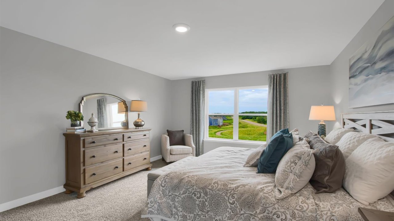 Bedroom suite with dual walk-in closets and private bathroom.