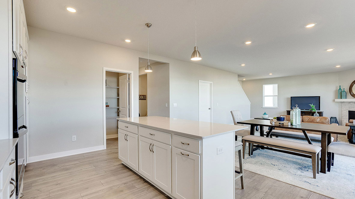 View of open concept main level with kitchen island in foreground.