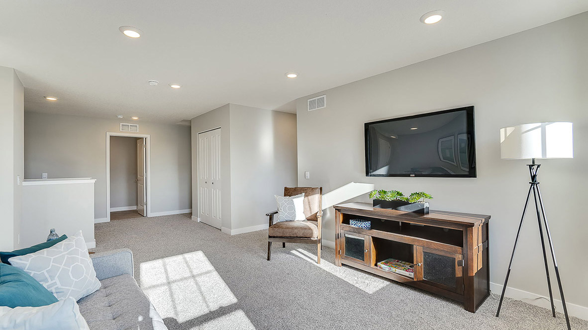 Upper level carpeted loft with living space.