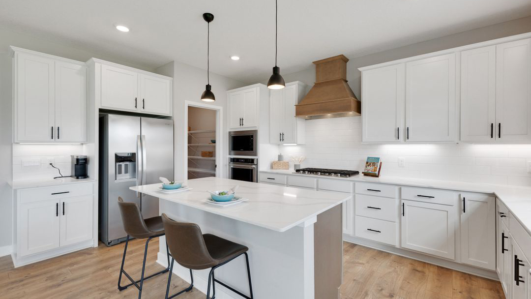 Kitchen island centered between the dining and living areas Prairie Pointe