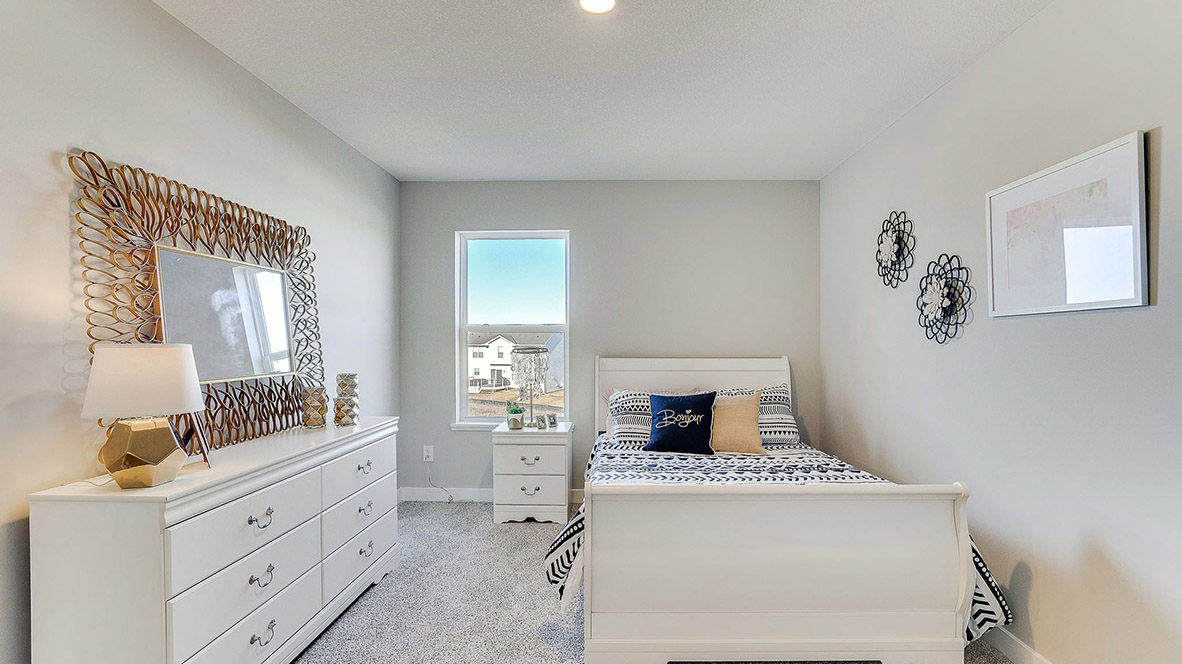 Secondary Bedroom Adams II Plan in Anton Village includes natural light, soft tones, and durable wall space for furniture