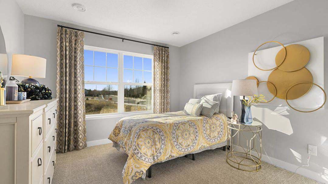 Carpeted secondary bedroom with standard size closet.