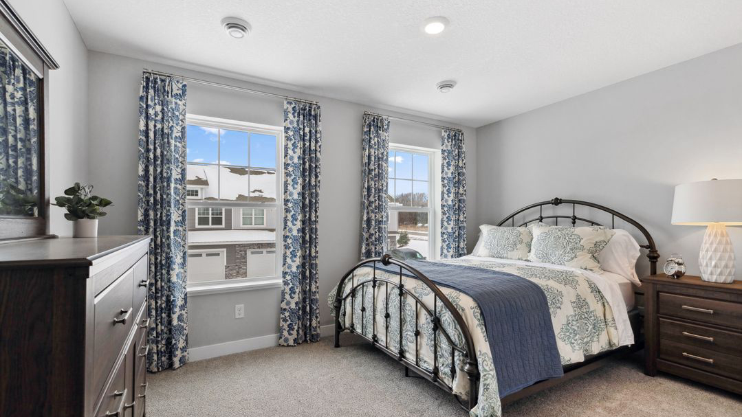 Carpeted secondary bedroom with standard size closet.