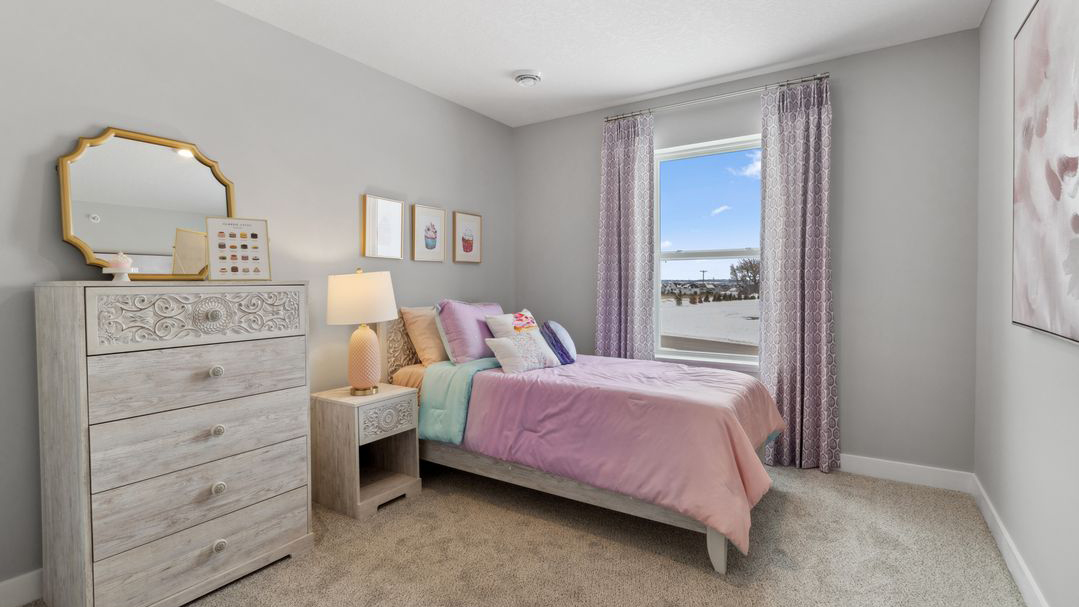 Carpeted secondary bedroom with standard size closet.
