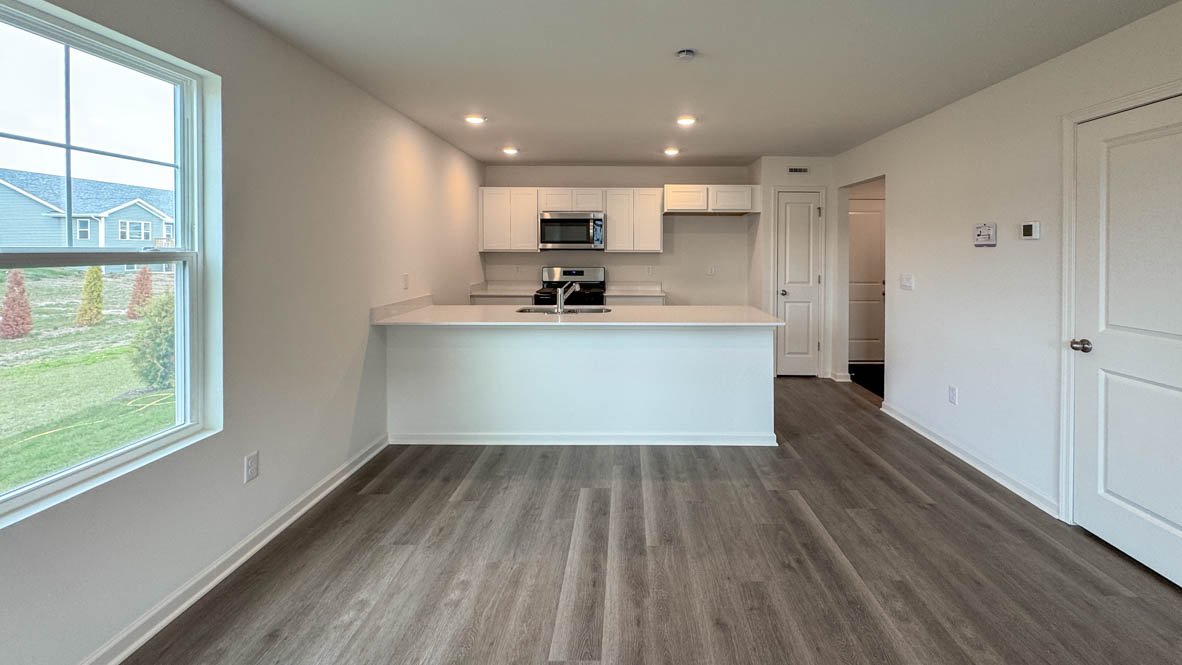 open concept kitchen with white cabinetry