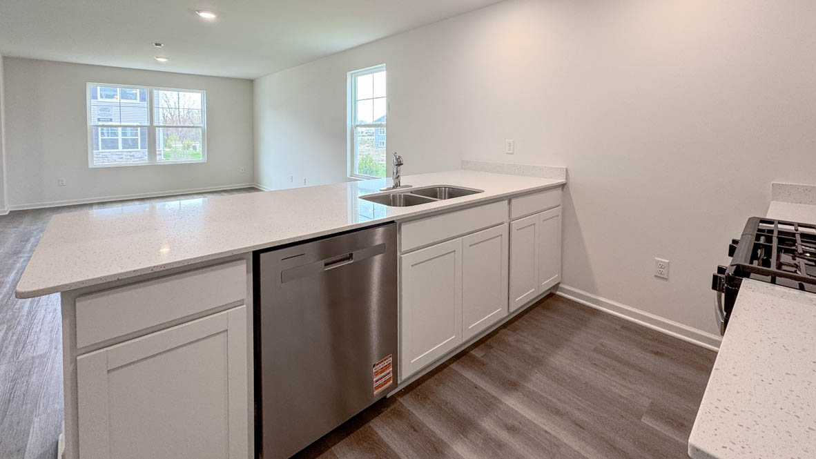 kitchen overlooking open concept living and dining rooms