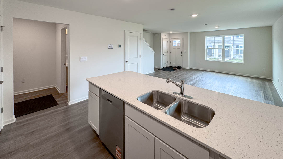 kitchen overlooking open concept dining and living rooms