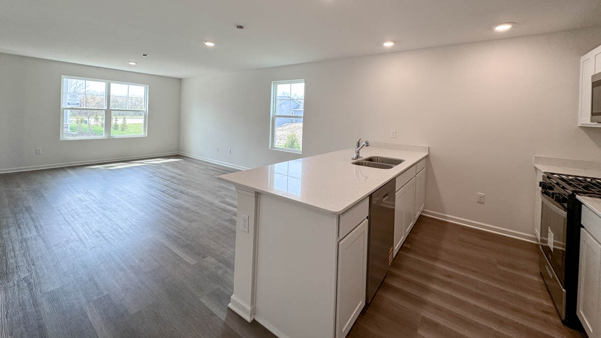 kitchen overlooking open concept living and dining rooms