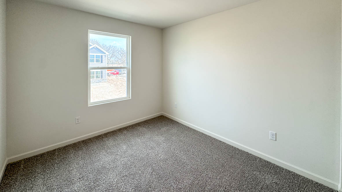 secondary bedroom with full carpet