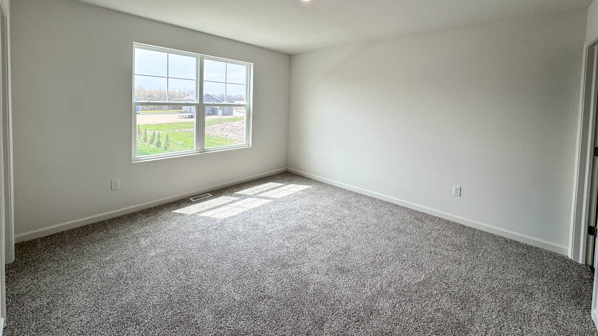 primary bedroom with large window and natural light