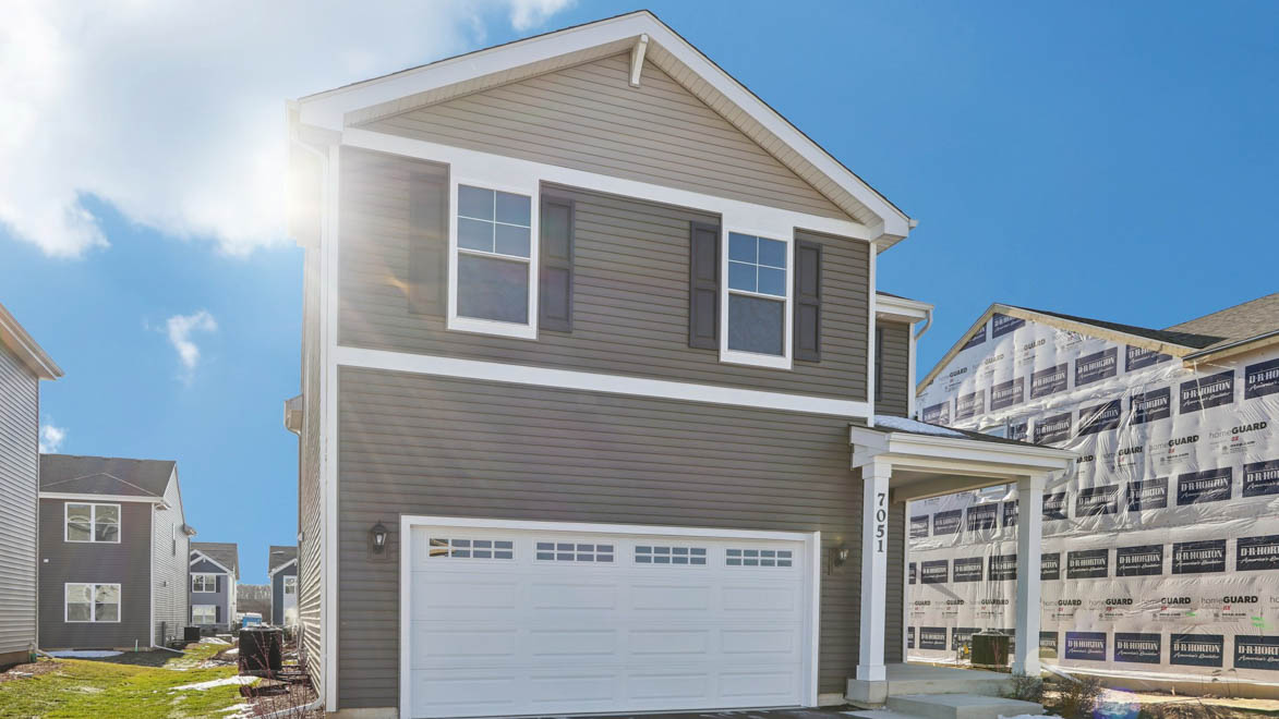 Two story sloan model with tan vinyl siding