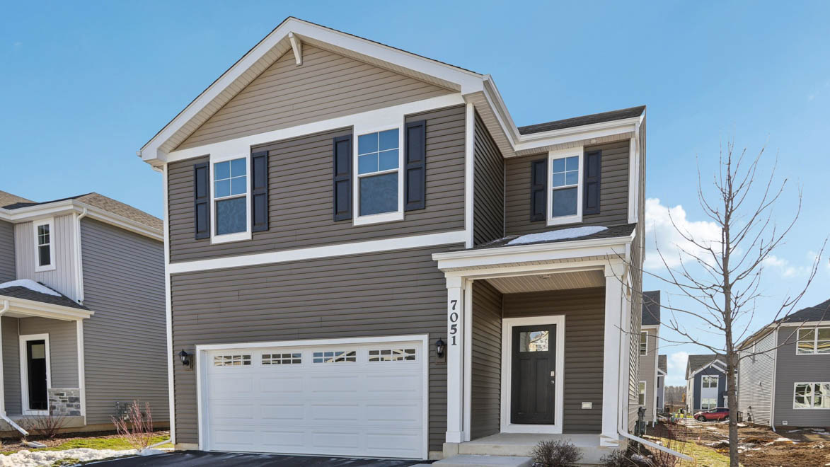 Sloan home with two car garage and paved driveway