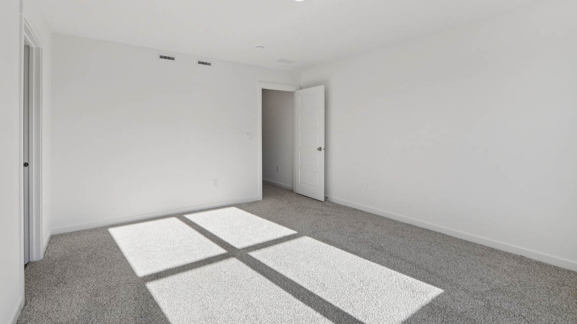 Primary bedroom to the right of staircase