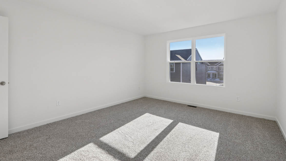 Primary bedroom with carpeting
