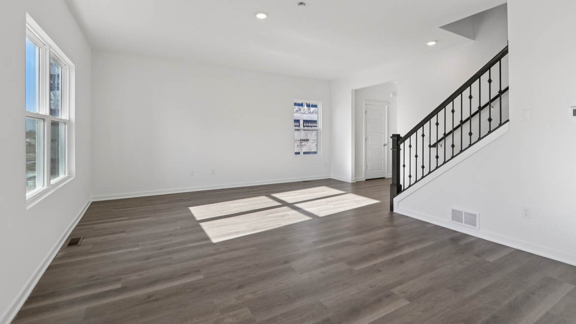 Great room with staircase leading upstairs