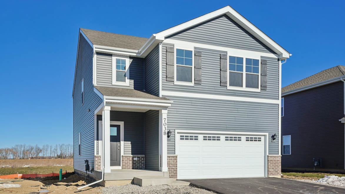 Hudson model with blue vinyl siding and brick accents