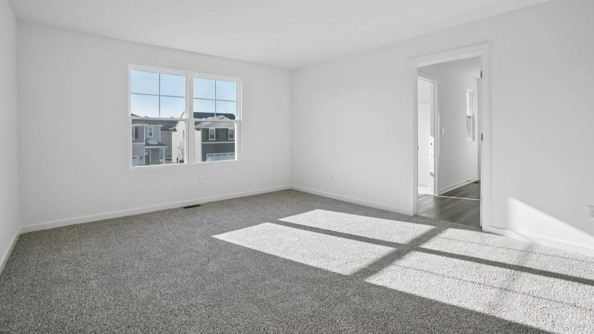 pacious primary bedroom with carpet
