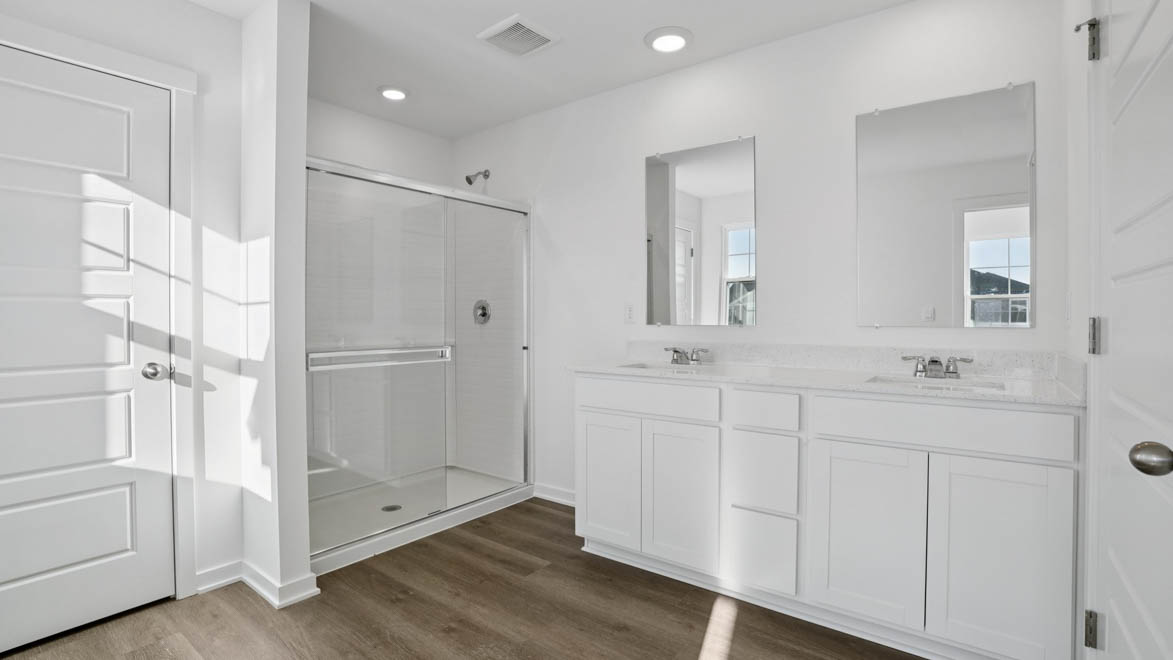 Primary bathroom with dual sinks and walk in shower