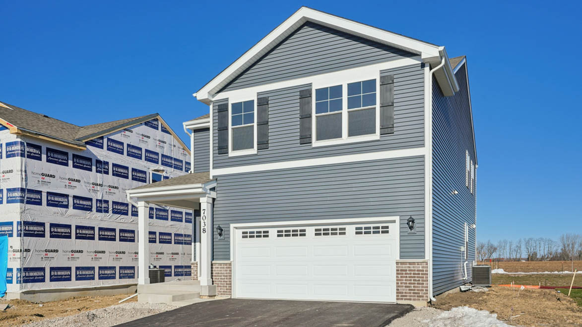 Hudson exterior with small front porch and paved driveway