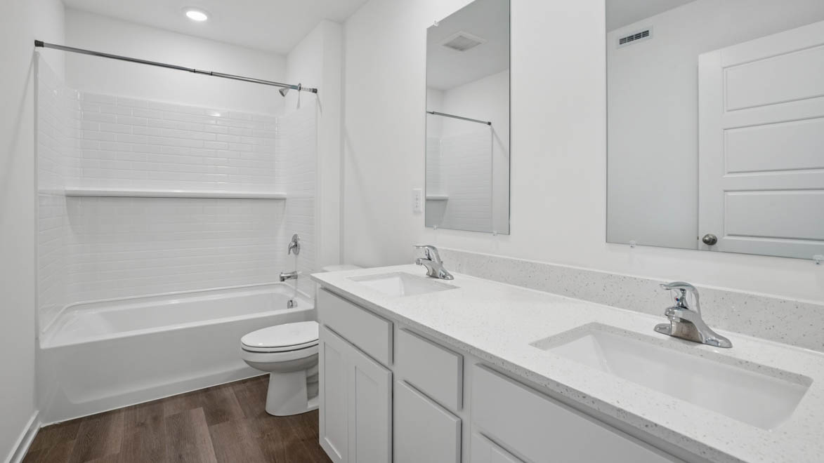 Secondary full bathroom with dual sinks