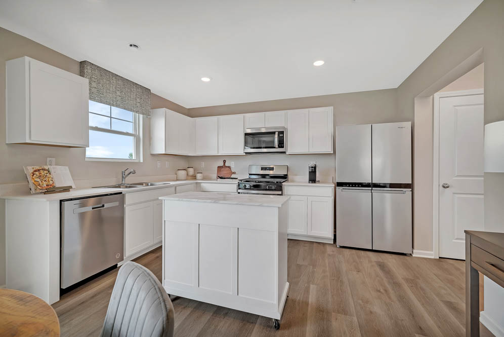 open concept kitchen with white cabinets